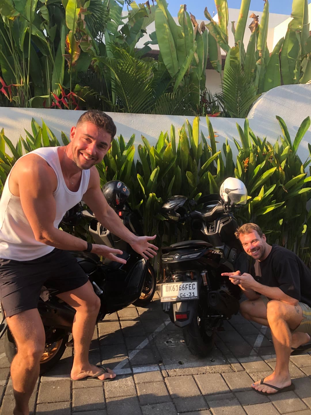 Happy SparkWash customers with their freshly washed Yamaha NMAX scooters at their villa in Bali