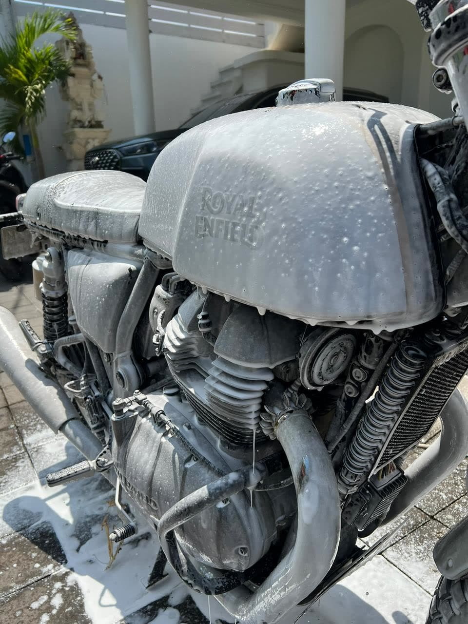Royal Enfield motorbike covered in snow foam during a SparkWash mobile wash in Bali